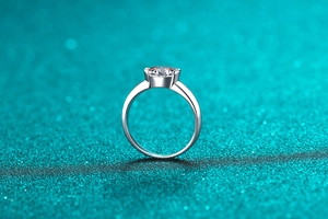 Detailed side view of silver ring featuring a large solitaire moissanite in four-prong setting
