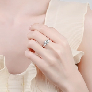 S925 sterling silver ring with oval cut moissanite and halo flower design on finger