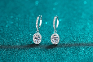Macro detail of S925 sterling silver hoop earrings featuring halo moissanite settings