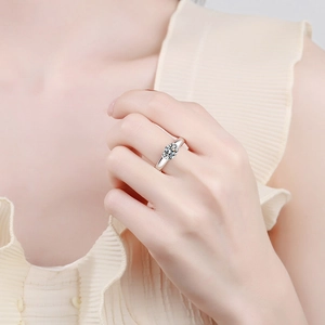 Minimalist S925 sterling silver solitaire moissanite ring worn on a woman's finger