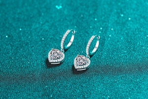 Macro shot of S925 silver heart hoop earrings with sparkling moissanite stones
