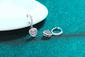 Macro shot of S925 silver heart earrings with sparkling moissanite stones