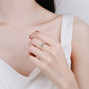 Elegant S925 sterling silver bow ring with sparkling moissanite on a female finger