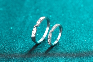 Macro shot of S925 sterling silver couple rings with geometric facets and pavé setting