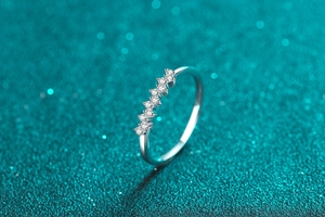 Macro shot of minimalist S925 sterling silver ring with delicate pave moissanite stones