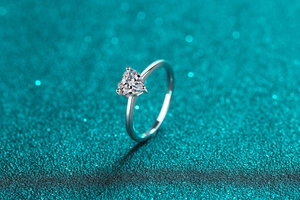 Detailed side view of a heart-cut moissanite stone set in a S925 sterling silver ring