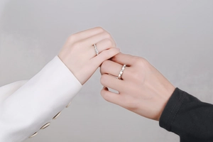 Close-up of S925 silver couple rings featuring pavé moissanite and geometric patterns