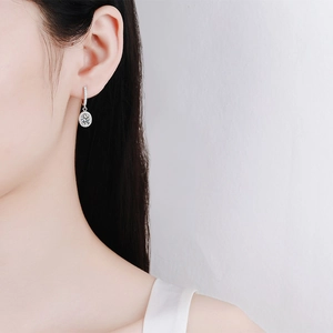 Elegant S925 sterling silver halo earrings with moissanite stones on a female model