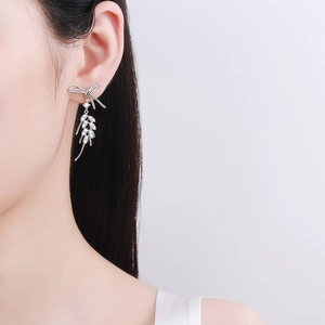 925 silver bow earrings with wheat zircon drops worn by model in a minimalist style