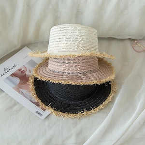 Flat top straw hats in beige, khaki, and black with trendy frayed edges for summer sun protection