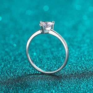 Sparkling S925 sterling silver heart-shaped moissanite engagement ring on blue glitter background