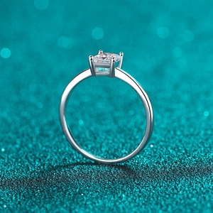 Elegant S925 sterling silver ring with princess cut moissanite on a blue bokeh background