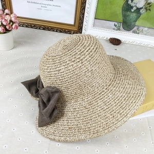 Women's straw sun hat with large bow and wide brim for summer beach protection