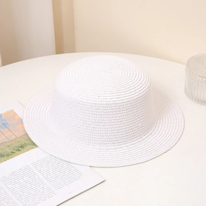 Detailed texture of white woven straw hat with minimalist flat top for summer sun protection