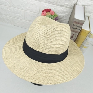 Straw Panama hat with wide black ribbon band for men and women on floral background