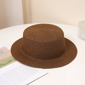 Close-up of a brown woven boater hat with a flat top and neat straw texture