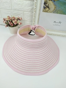 Detail of pink and white striped straw sun visor with adjustable inner sweatband
