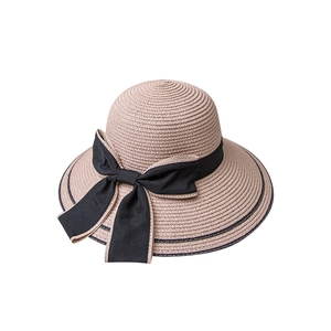 Stylish wide brim straw sun hat for women featuring a black bow and ribbon decoration
