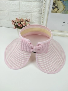 Detailed back view of pink and white striped straw visor featuring a large decorative bow