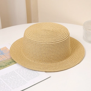 Close-up of natural beige boater hat showing detailed straw weaving and flat brim texture