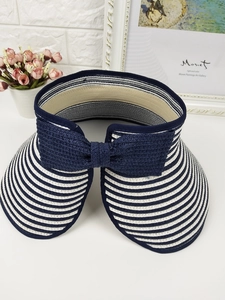 Blue and white striped straw sun visor featuring a large decorative rear bow detail