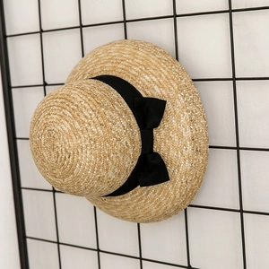 Ethnic straw dome sun hat with black ribbon bow for outdoor heat protection
