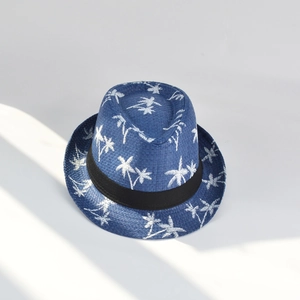 Men's blue straw fedora with white palm tree embroidery and black band in summer sunlight