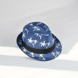 Close-up of blue straw fedora hat featuring white coconut tree prints and black band