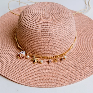 Pink woven straw sun hat with shell and gold starfish chain decoration