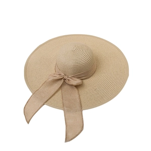 Elegant wide brim straw hat for women with beige ribbon bow for sun protection