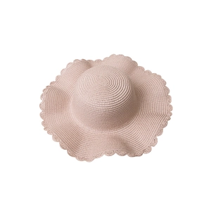 Pink wide-brimmed paper woven sun hat with stylish wavy edges for summer beach wear
