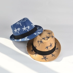 Detail of paper straw trilby hats with palm tree prints and black ribbon bands