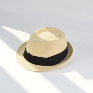 Detail of light beige woven Panama hat featuring a classic black decorative ribbon band