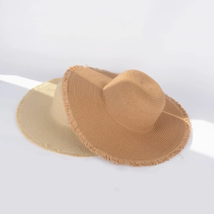 Detailed macro view of woven straw hats showing natural texture and frayed edges