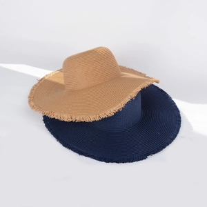 Detailed close-up of wide-brim straw hats with frayed edges in khaki and navy blue