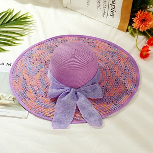Elegant purple wide-brim straw hat with colorful dots and a chiffon bow for summer travel