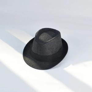 Close-up of the woven texture and decorative ribbon on a black summer straw fedora hat