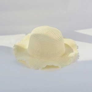 Close-up of a light yellow woven straw hat featuring a wavy brim and spiral knit texture