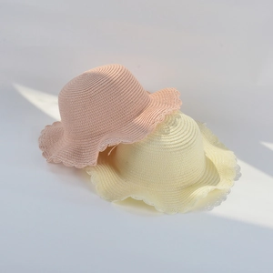 Detailed close-up showing the woven texture and wavy scalloped edge of these summer straw hats