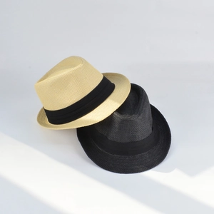 Close-up of woven straw Panama hats in beige and black with decorative ribbons