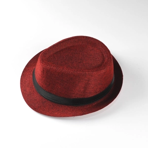 Detail view of burgundy woven straw Fedora hat with black ribbon band and textured finish