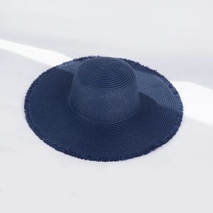 Close-up of dark blue wide-brim straw hat featuring detailed fringe edge and woven texture