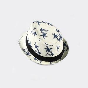 Detail view of woven Panama hat with navy palm tree prints and a black band