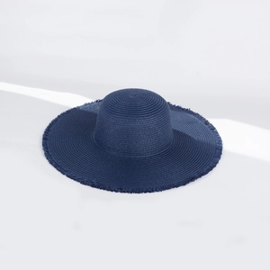 Detail of navy blue straw sun hat with frayed edge design and natural woven texture