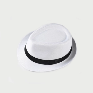 Detail of the woven texture and black ribbon on a white linen summer jazz hat
