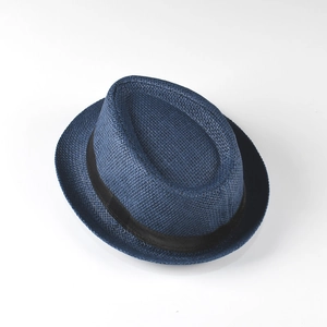 Détail d'un chapeau Panama en paille bleu marine avec tissage fin et ruban noir décoratif