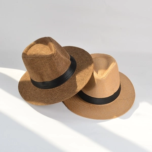 Top view of dark brown and beige straw fedora hats with black ribbons for sun protection