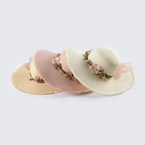 Detail showing wide-brim straw hats with floral decor and fringe edges in three colors