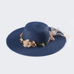 Navy blue wide brim straw sun hat for women with elegant floral decor and ribbon