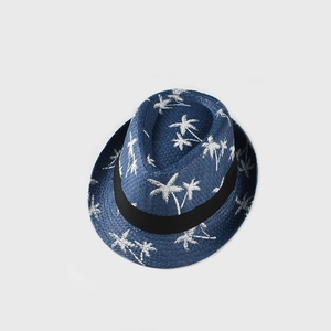 Close-up of blue straw fedora with white coconut tree embroidery and black band ribbon